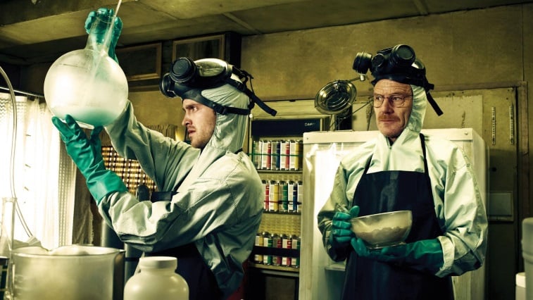 Bryan Cranston and Aaron Paul are dressed in hazmat suits as they mix up their Blue Sky product.
