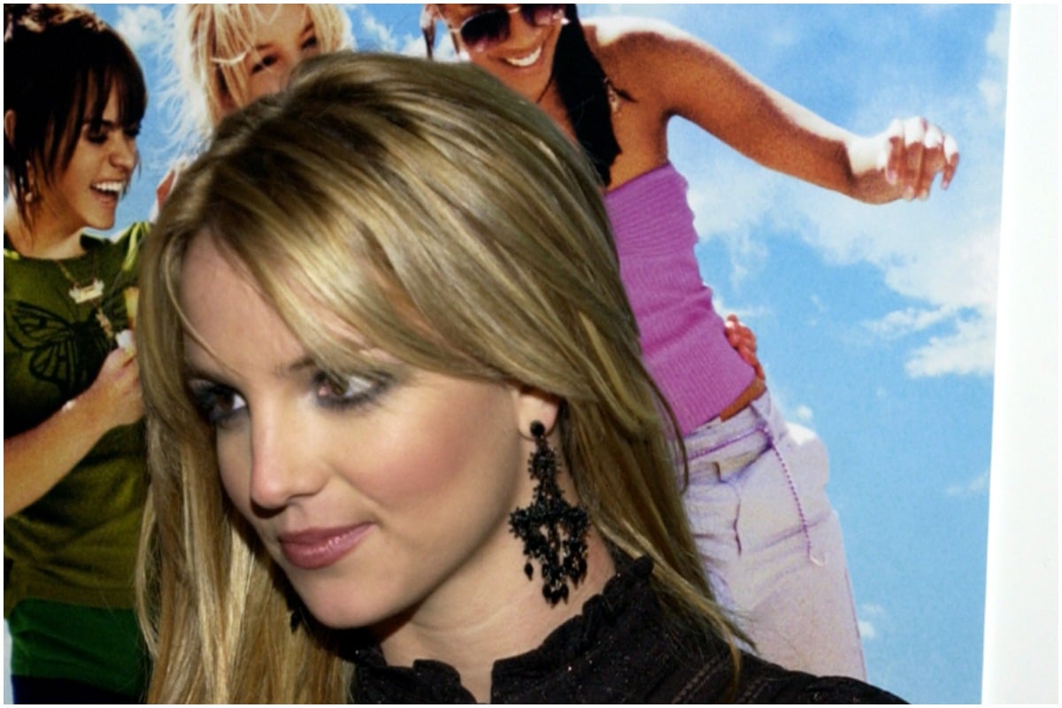 Britney Spears attending the 'Crossroads' premiere smiling while looking away from the camera.