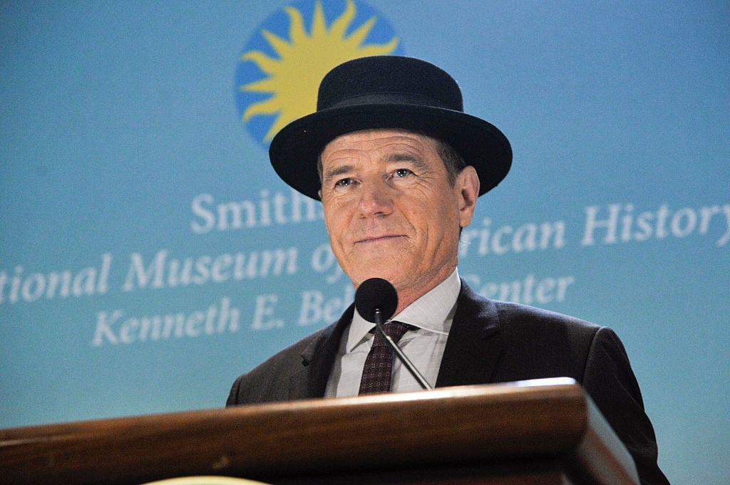 Bryan Cranston speaks at the Smithsonian while wearing his 'Heisenberg' hat.