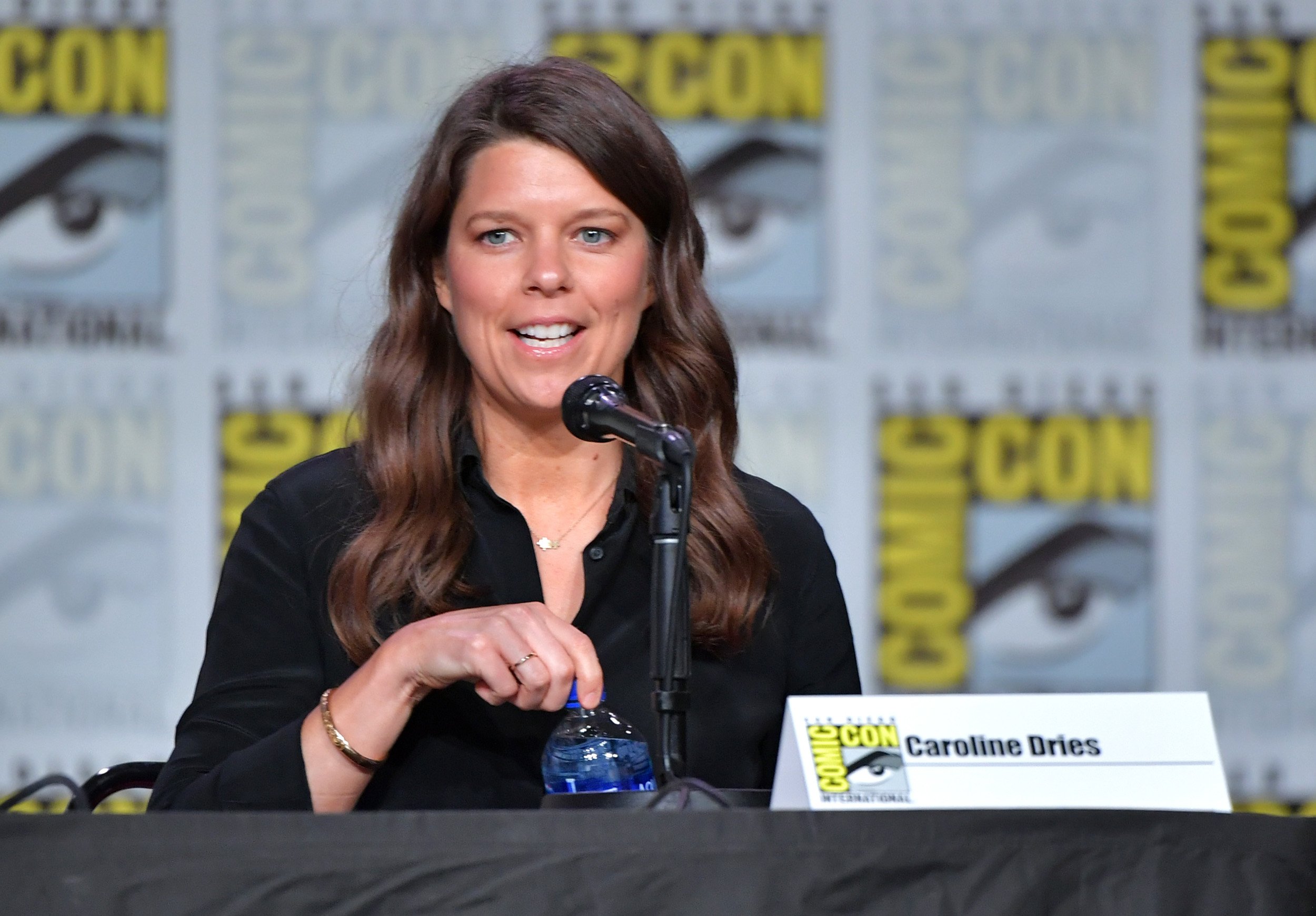 'Batwoman' showrunner Caroline Dries wearing a black shirt and sitting on a panel at San Diego Comic-Con