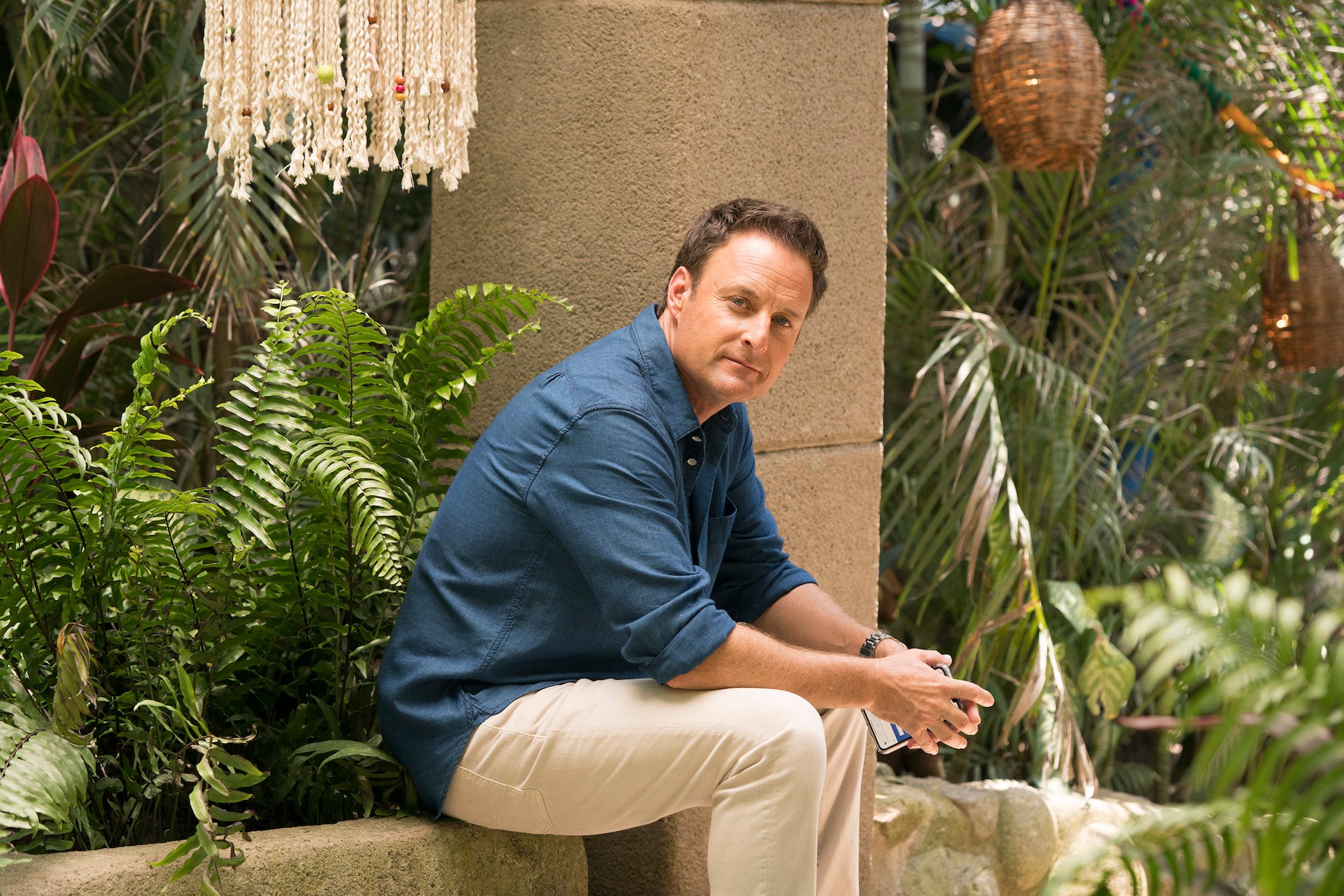 Chris Harrison, former host of 'The Bachelor' and 'The Bachelorette,' sitting outside on 'Bachelor in Paradise' staring at the camera