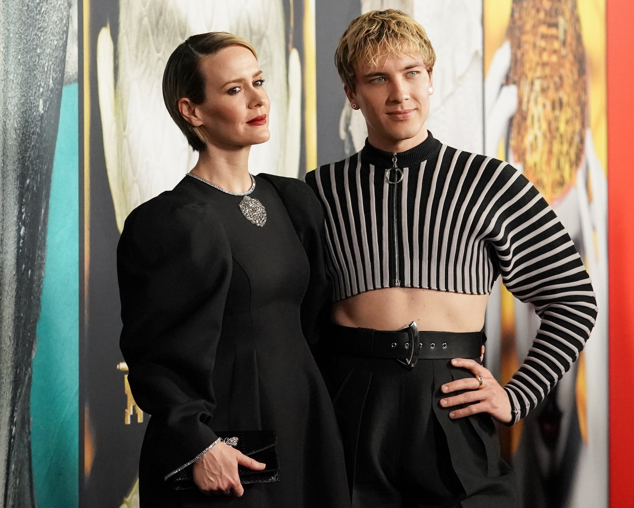 Sarah Paulson and Cody Fern attend FX's 'American Horror Story' 100th Episode Celebration, posing in front of a poster