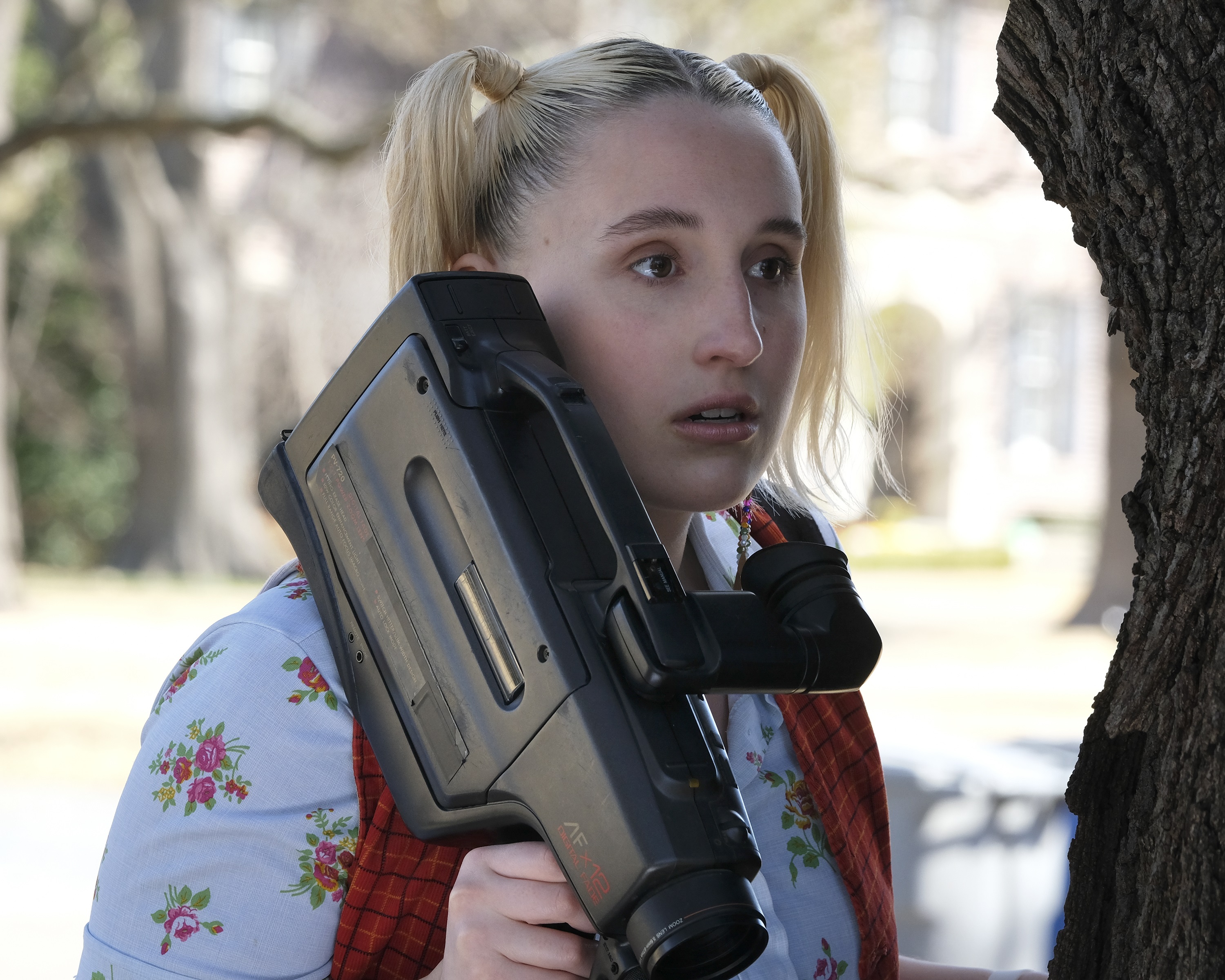Cruel Summer Mallory Higgins holding a video camera looking at Martin Harris house