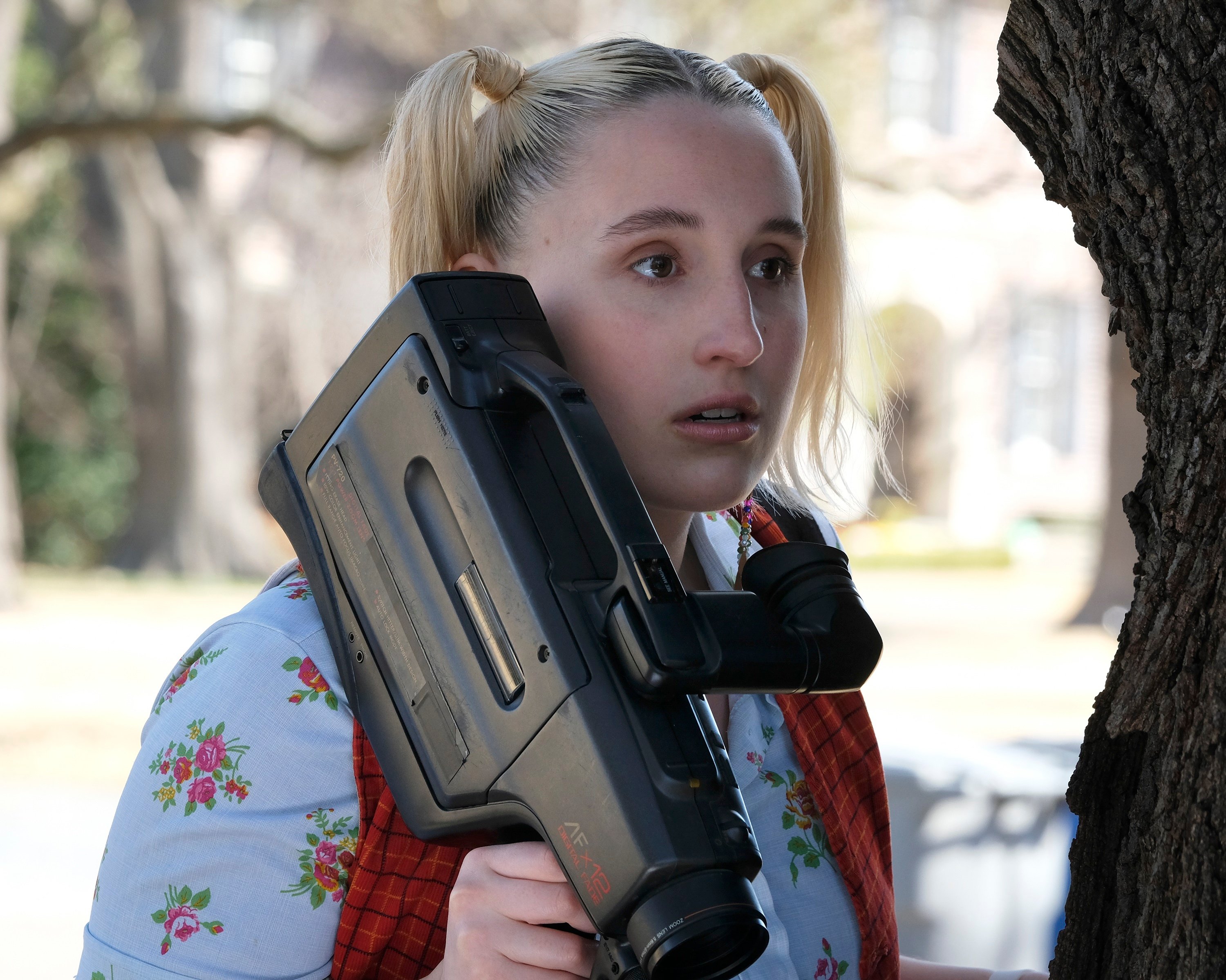Cruel Summer Season 1 cast member Mallory Higgins holding a video camera looking at Martin Harris house