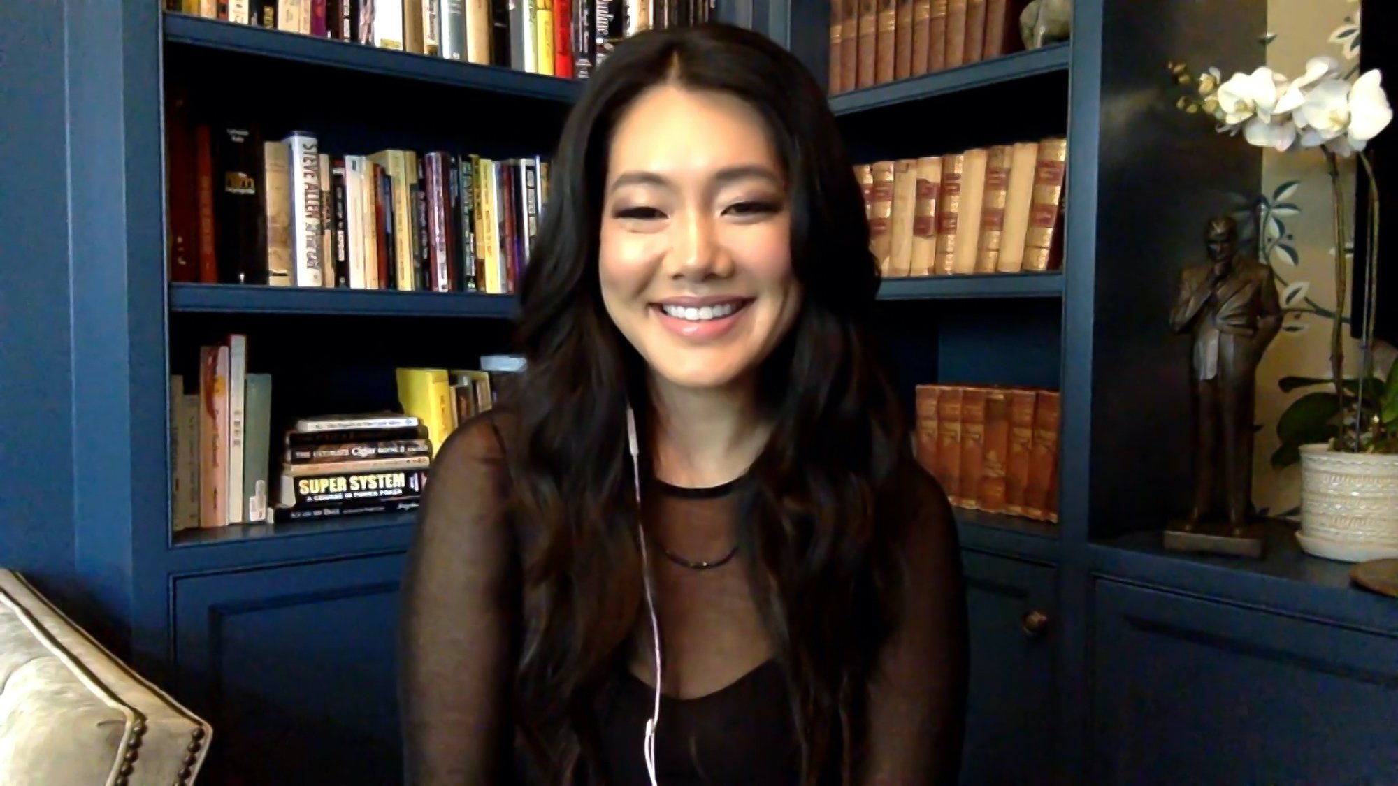 Crystal Kung Minkoff smiling in front of bookshelves