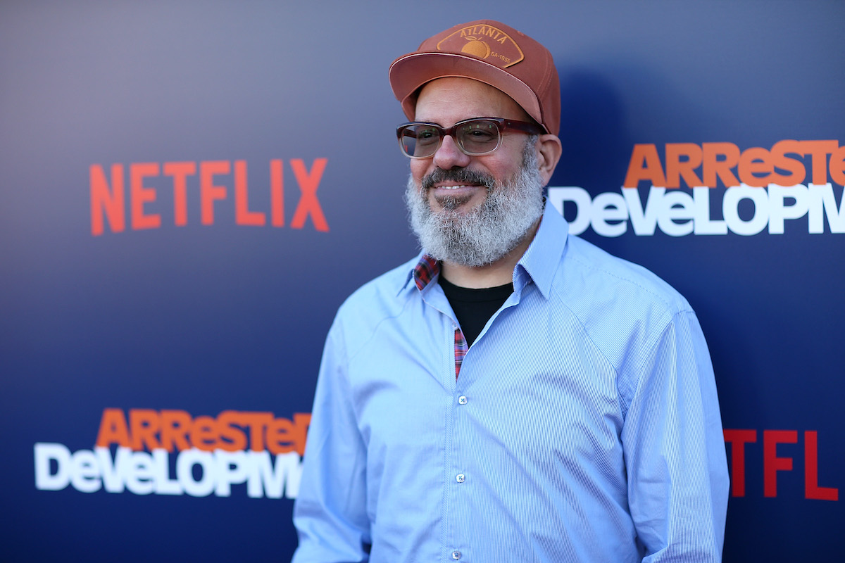 David Cross poses for a photo at an event for 'Arrested Development' wearing a basketball cap and shirt