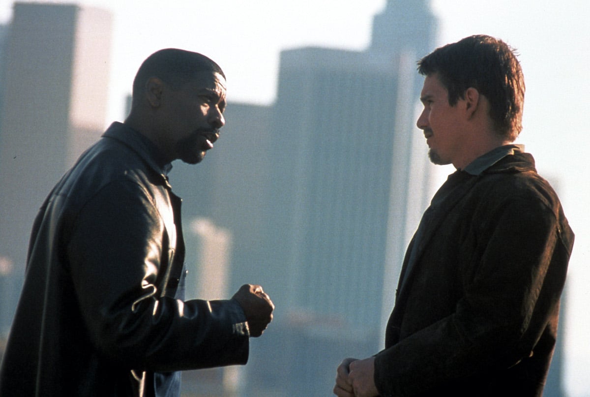 Alonzo Harris (Denzel Washington) talks to Jake Hoyt (Ethan Hawke) amid a cityscape in the movie 'Training Day'