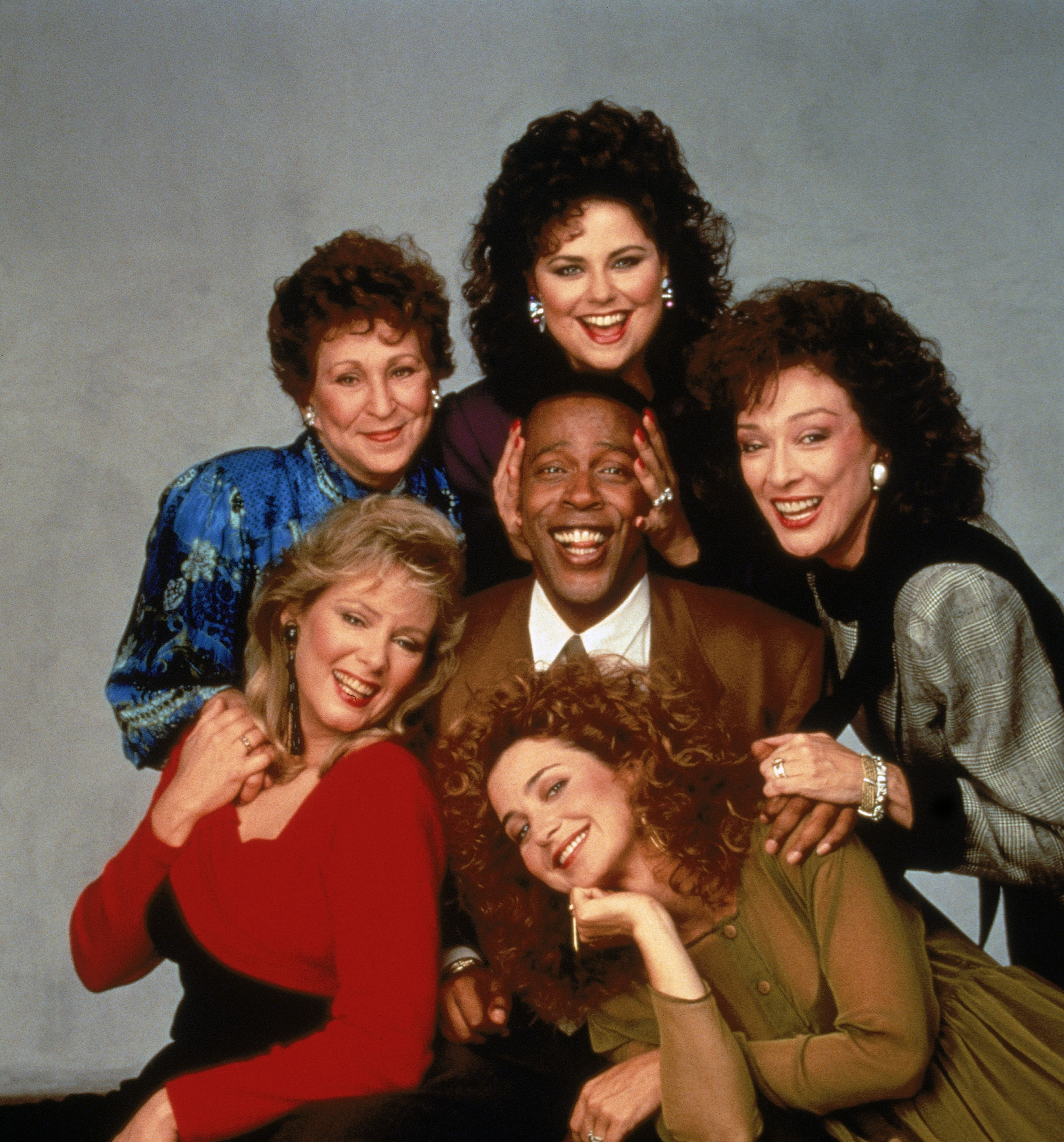 Jean Smart, Alice Ghostley, Delta Burke, Dixie Carter, Annie Potts and Meshach Taylor sit for a promotional photo for 'Designing Women' in 1987