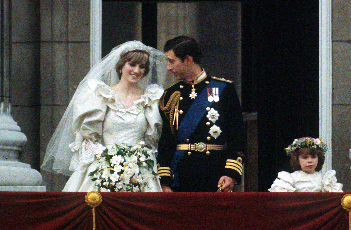 Princess Diana and Prince Charles laughing, standing on a balcony on their wedding day