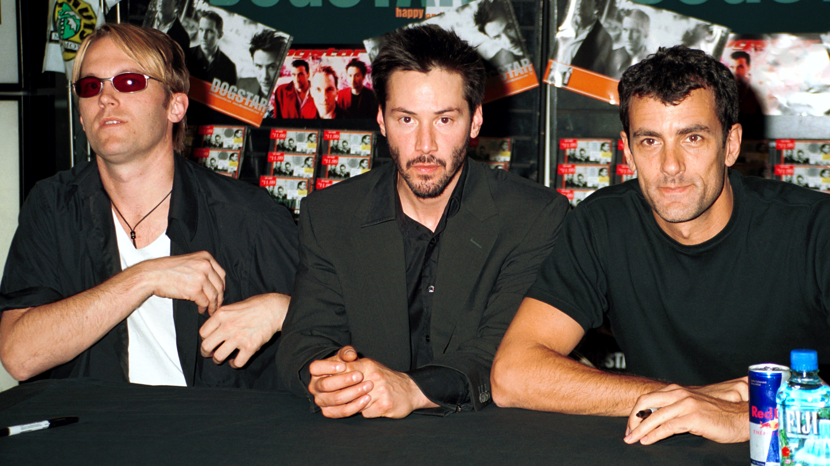 Dogstar trio sits at a record store table