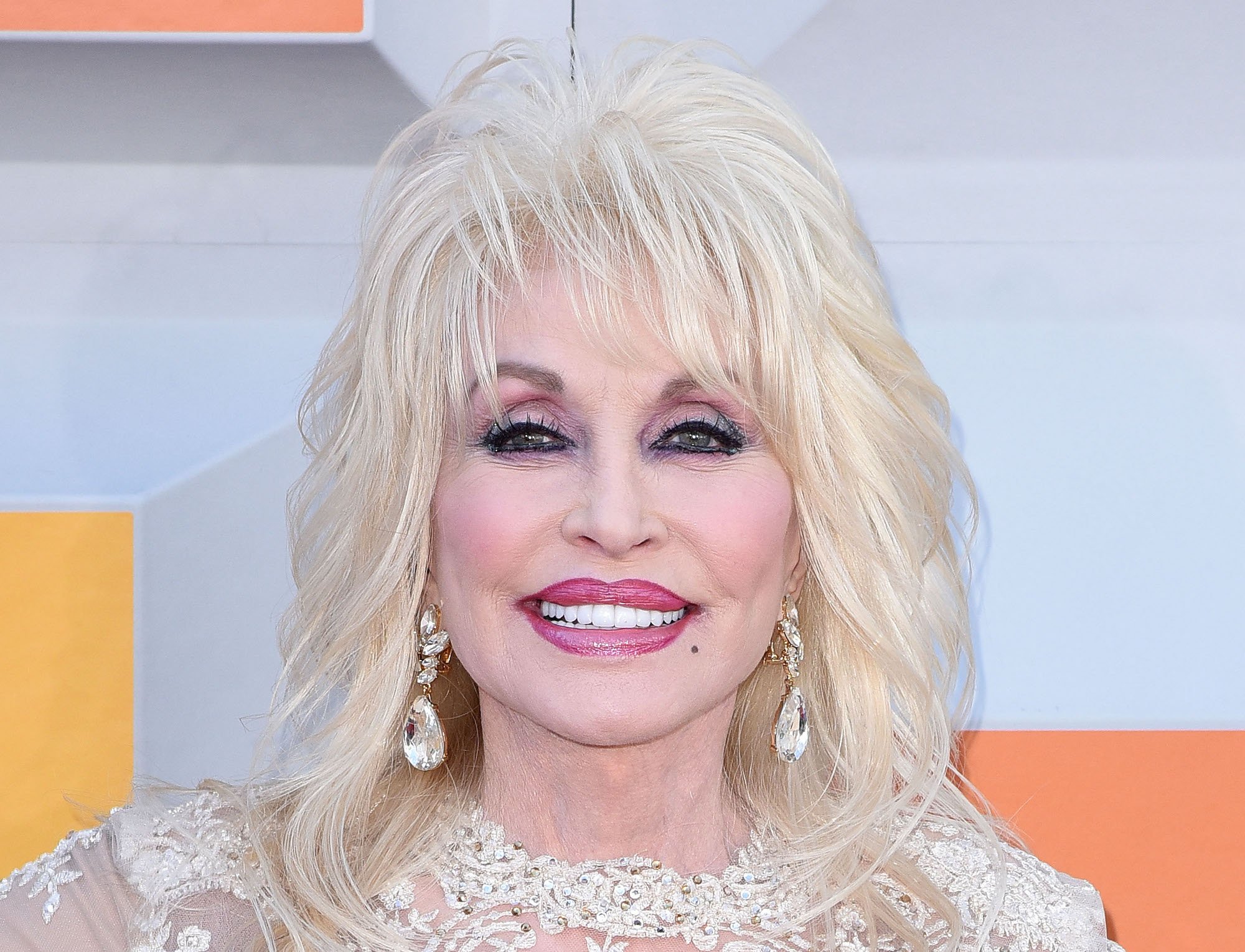 Dolly Parton posing on the red carpet at the 51st Academy Of Country Music Awards in 2016