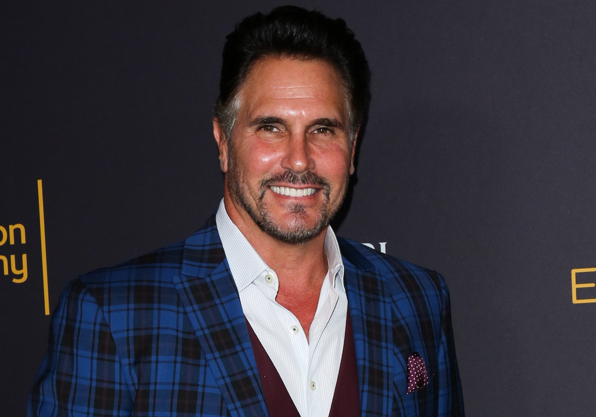 Don Diamont smiling in front of a dark background