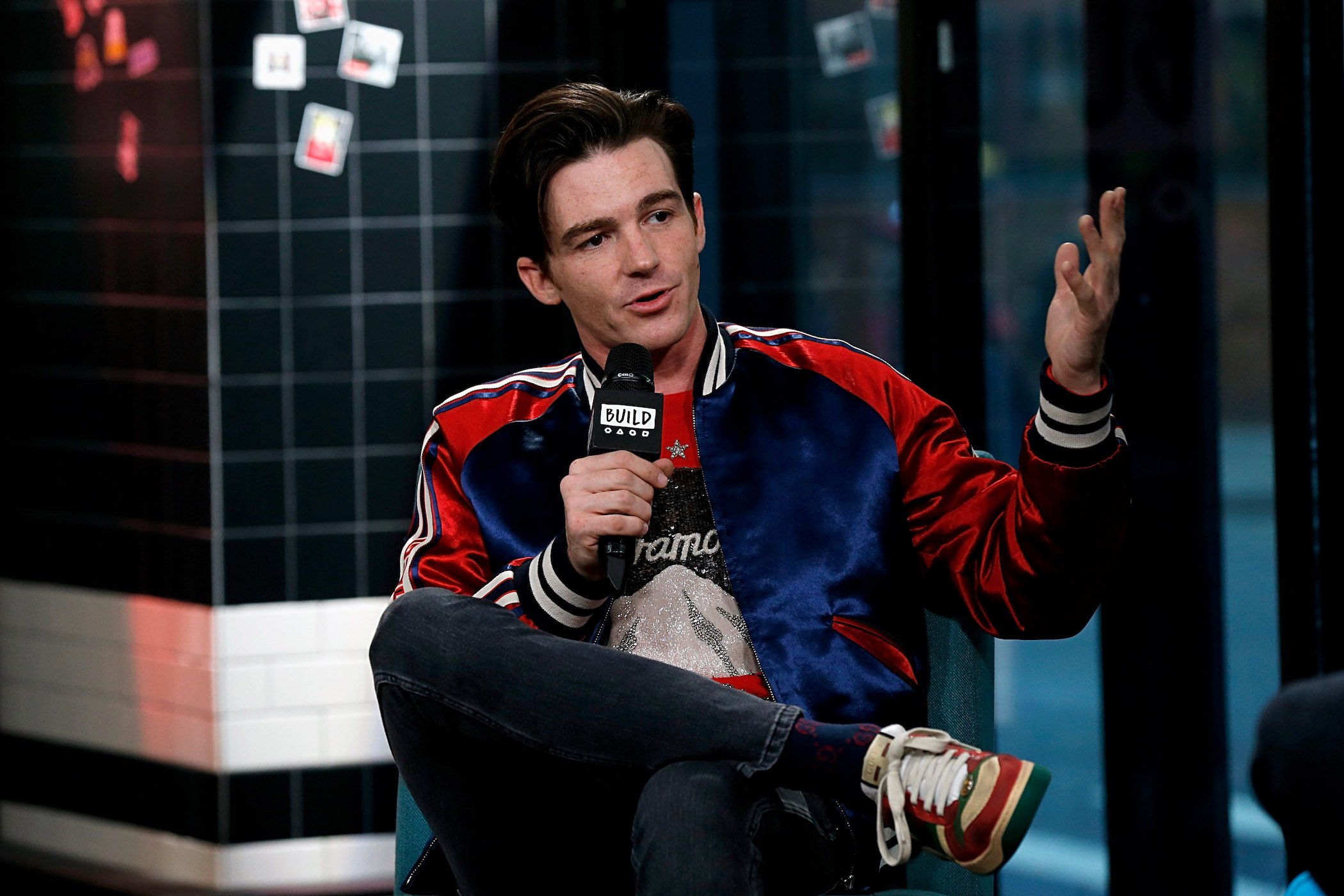 'Drake & Josh' star Drake Bell at the age of 33 sitting and talking into a microphone