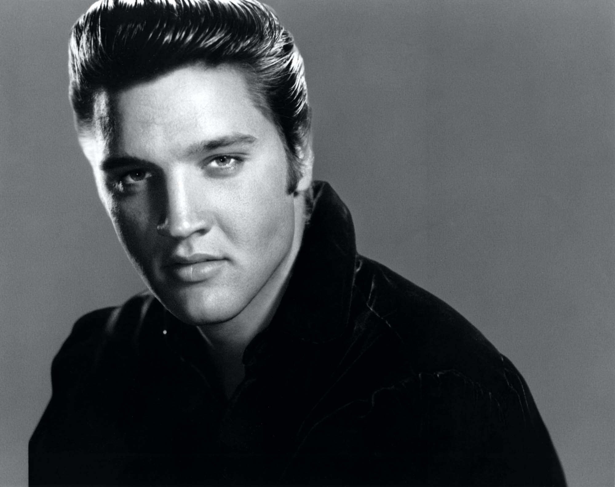 Elvis Presley looking at the camera, in black and white