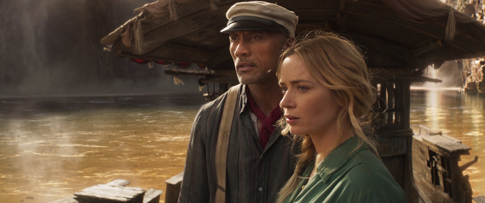 Emily Blunt and Dwayne 'The Rock' Johnson star in Disney's original movie, 'The Jungle Cruise' looking off into the distance in a still from the film