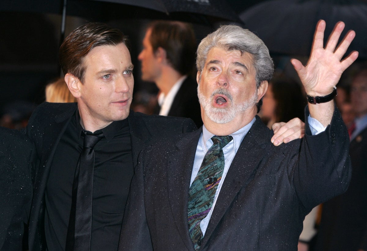 Ewan McGregor stands next to George Lucas, who is speaking, at the UK premiere of 'Star Wars: Episode III — Revenge Of The Sith'