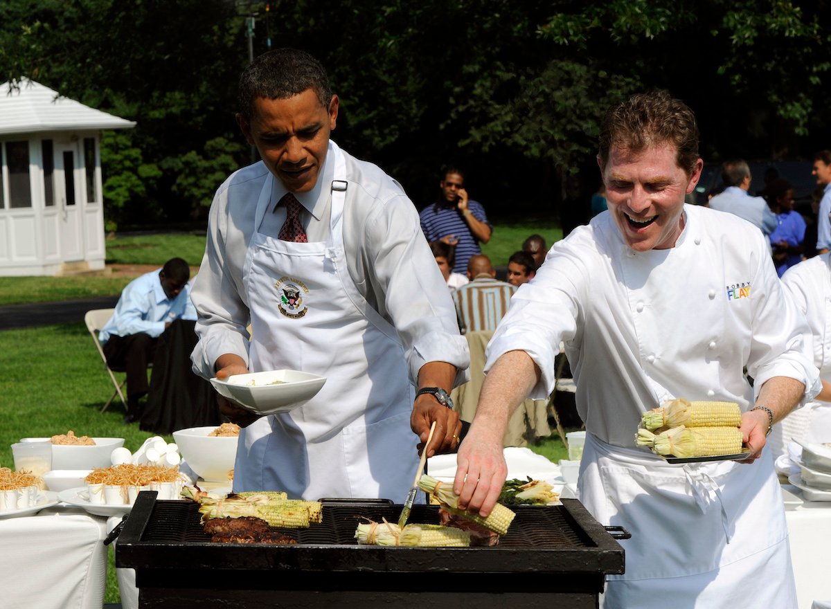 Former president Barack Obama and Bobby Flay grilling corn on the cob