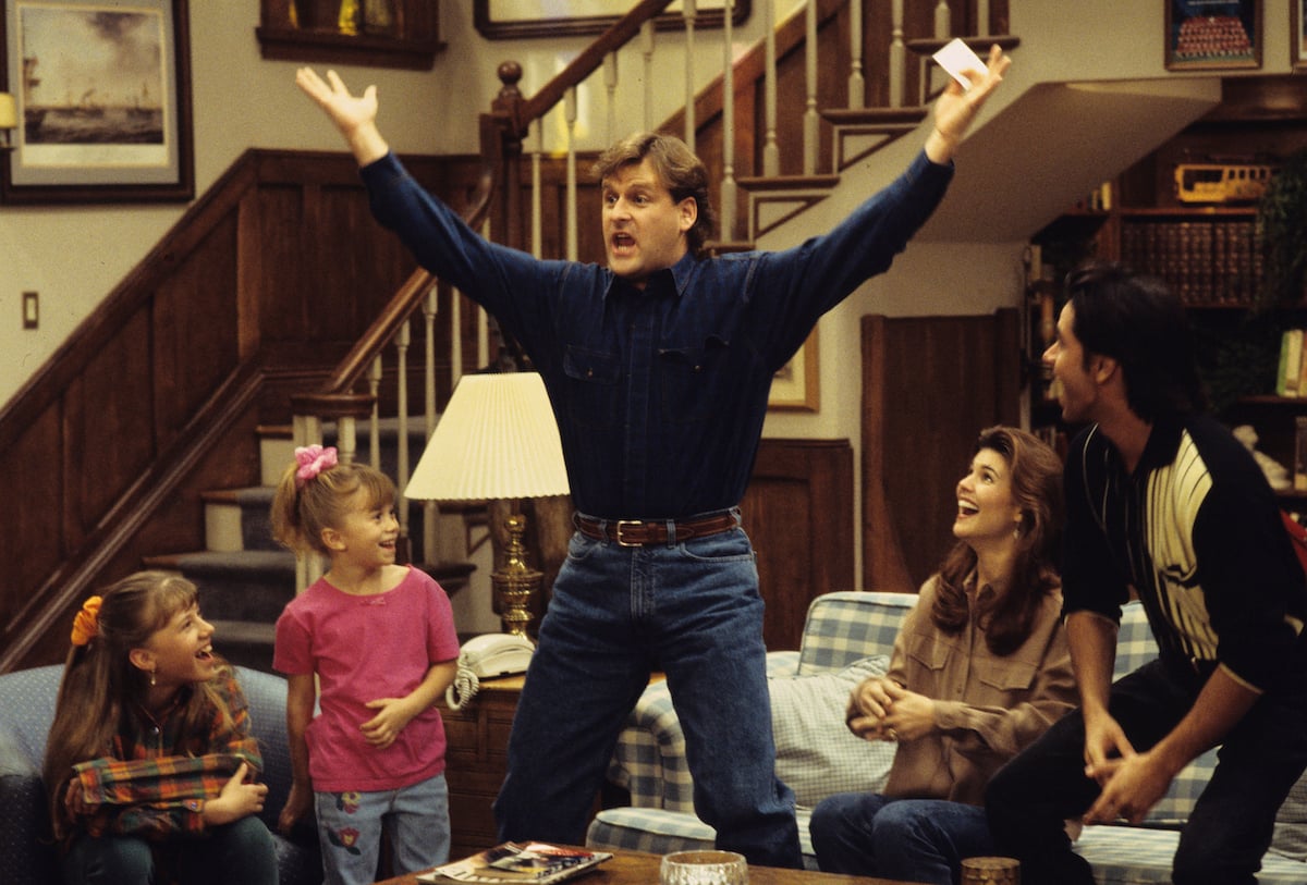 'Love on the Rocks' episode of 'Full House' featuring Dave Coulier as Joey Gladstone, Joey Gladstone standing up from the couch in excitement