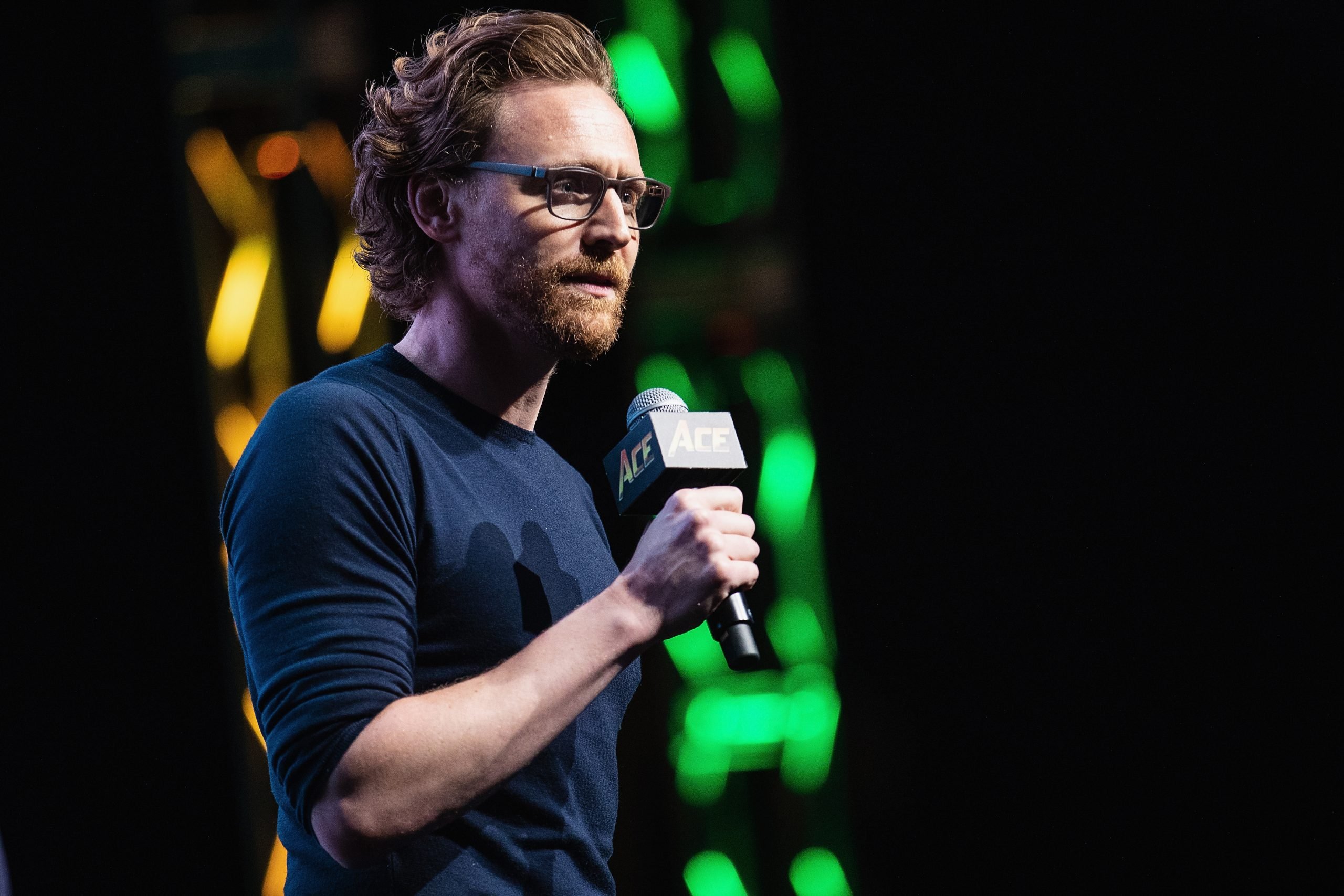 Tom Hiddleston speaks on stage about life as Loki in the Marvel Universe