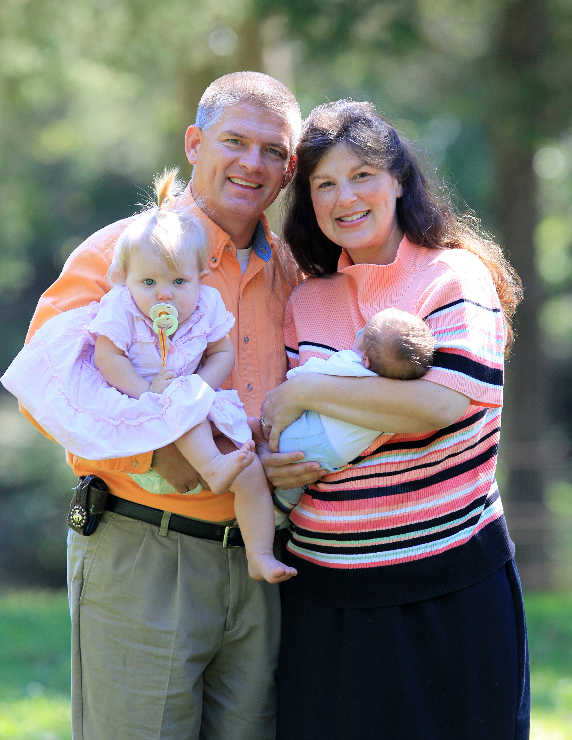 Gil Bates and kelly Jo Bates hold two of the family's babies in 2010