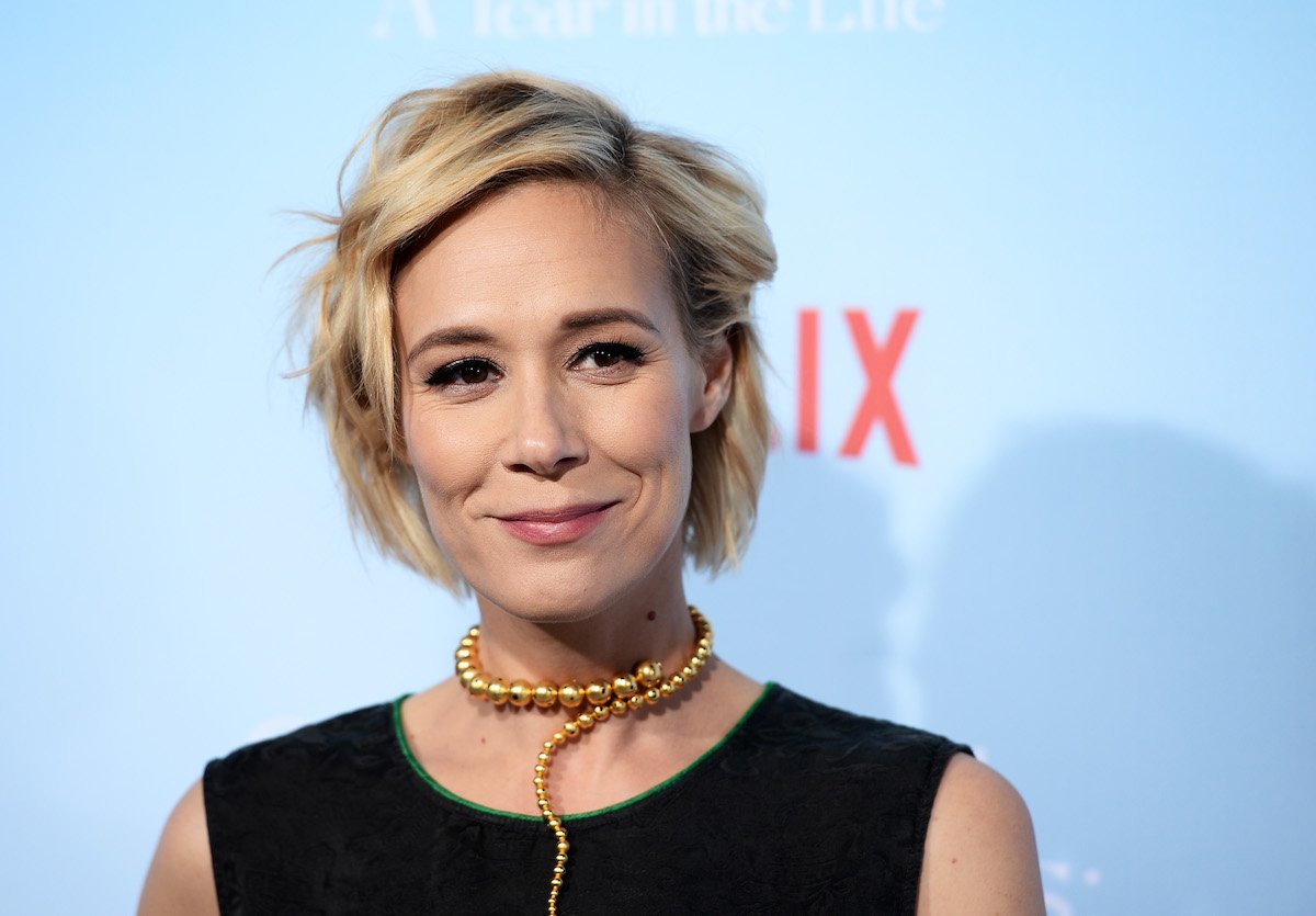 Liza Weil smiles as she poses on a red carpet for 'Gilmore Girls: A Year in the Life'