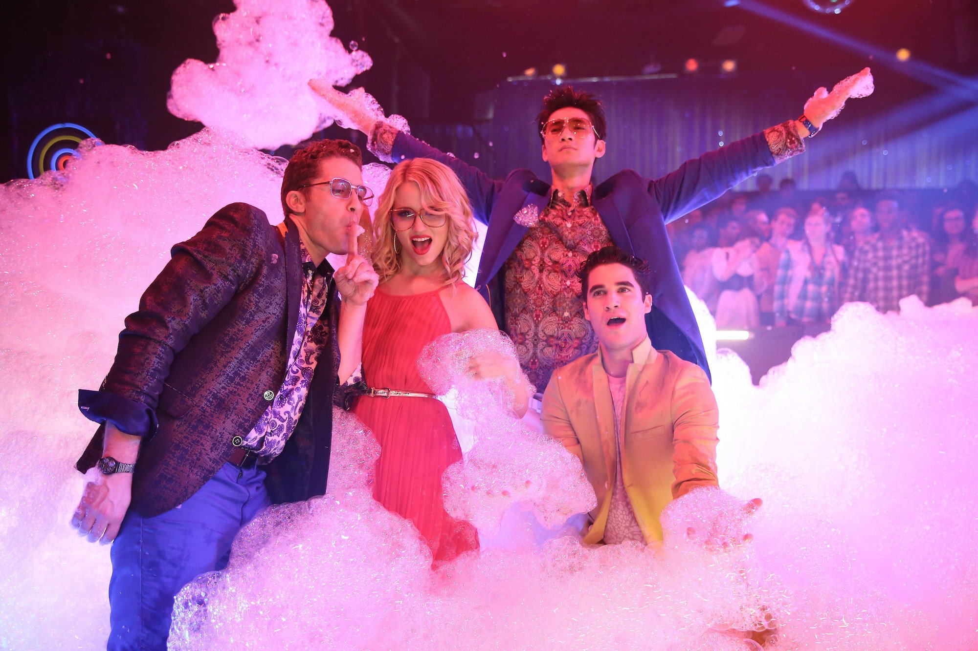 'Glee' cast members singing on a stage full of bubbles