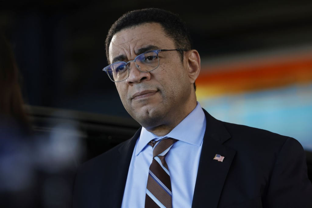 Harry Lennix as Harold Cooper looks on. He is dressed in a suit and tie. He also wears glasses.