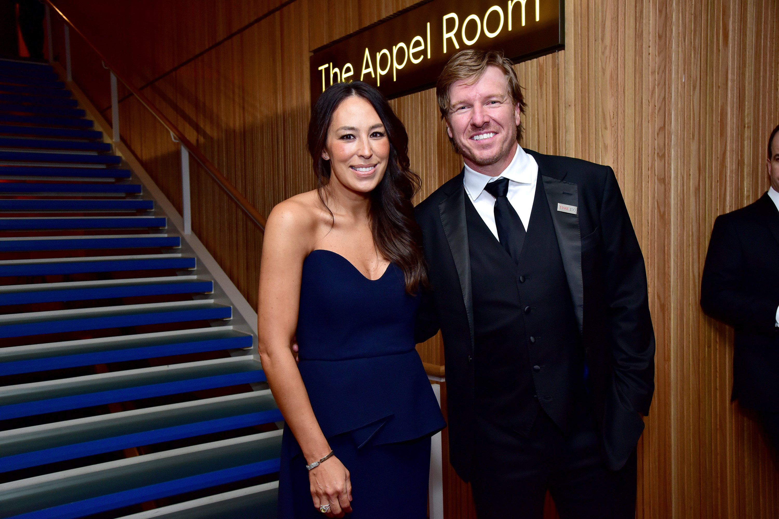Joanna Gaines in a blue strapless dress and Chip Gaines in a tux