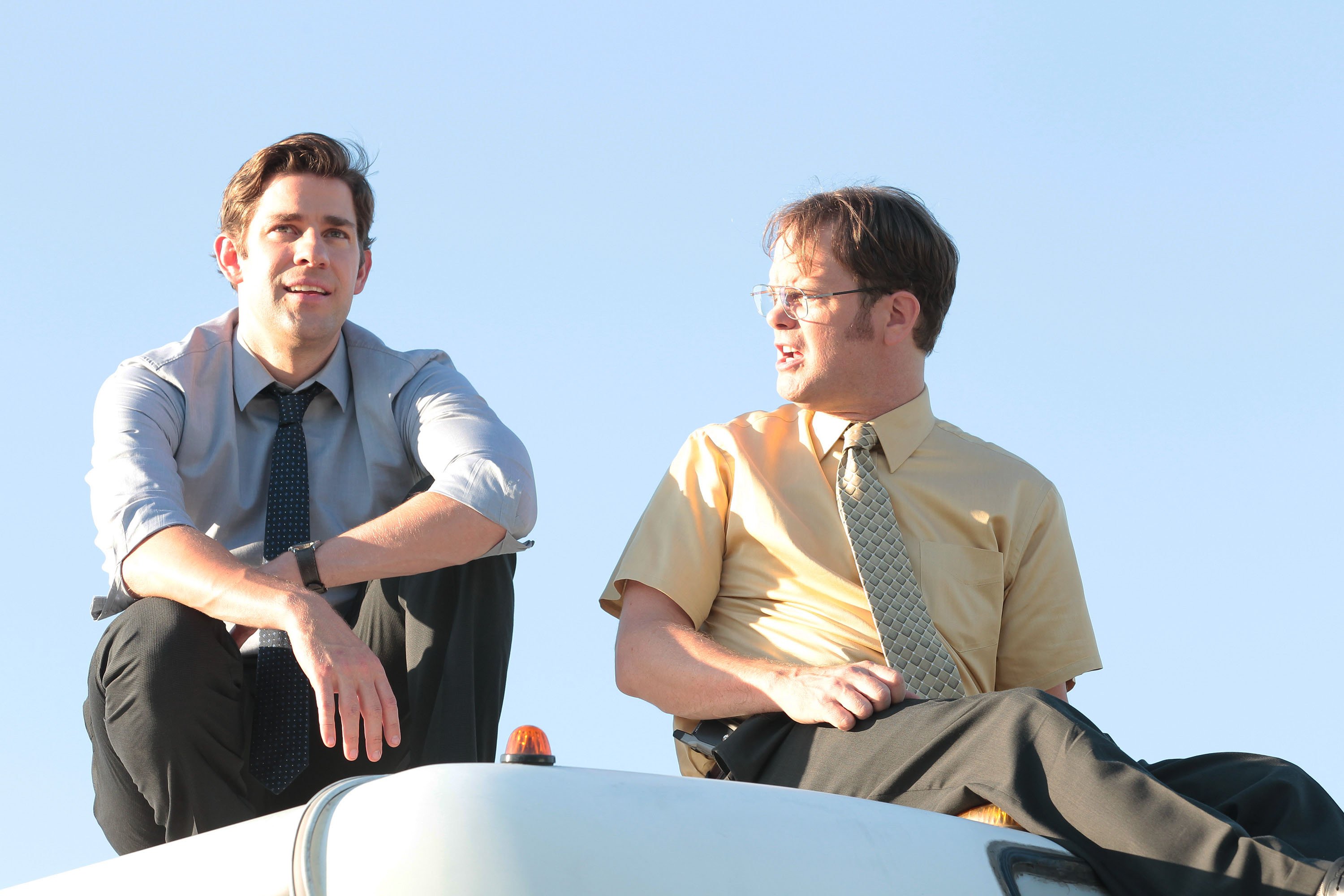 The Office stars John Krasinski and Rainn Wilson as Jim and Dwight on top of a bus