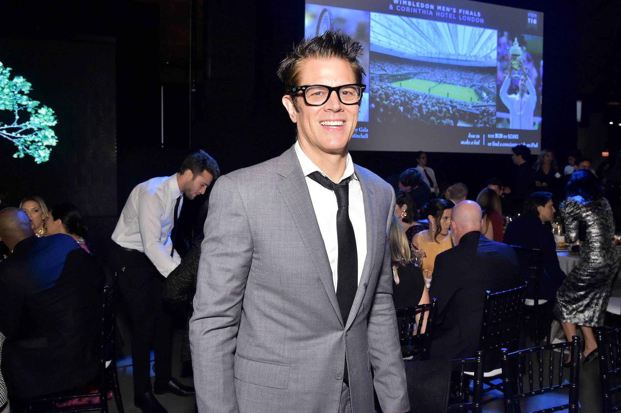 Johnny Knoxville smiling in front of a crowd of people