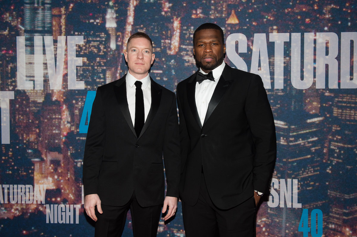 Joseph Sikora and 50 Cent wearing black uits