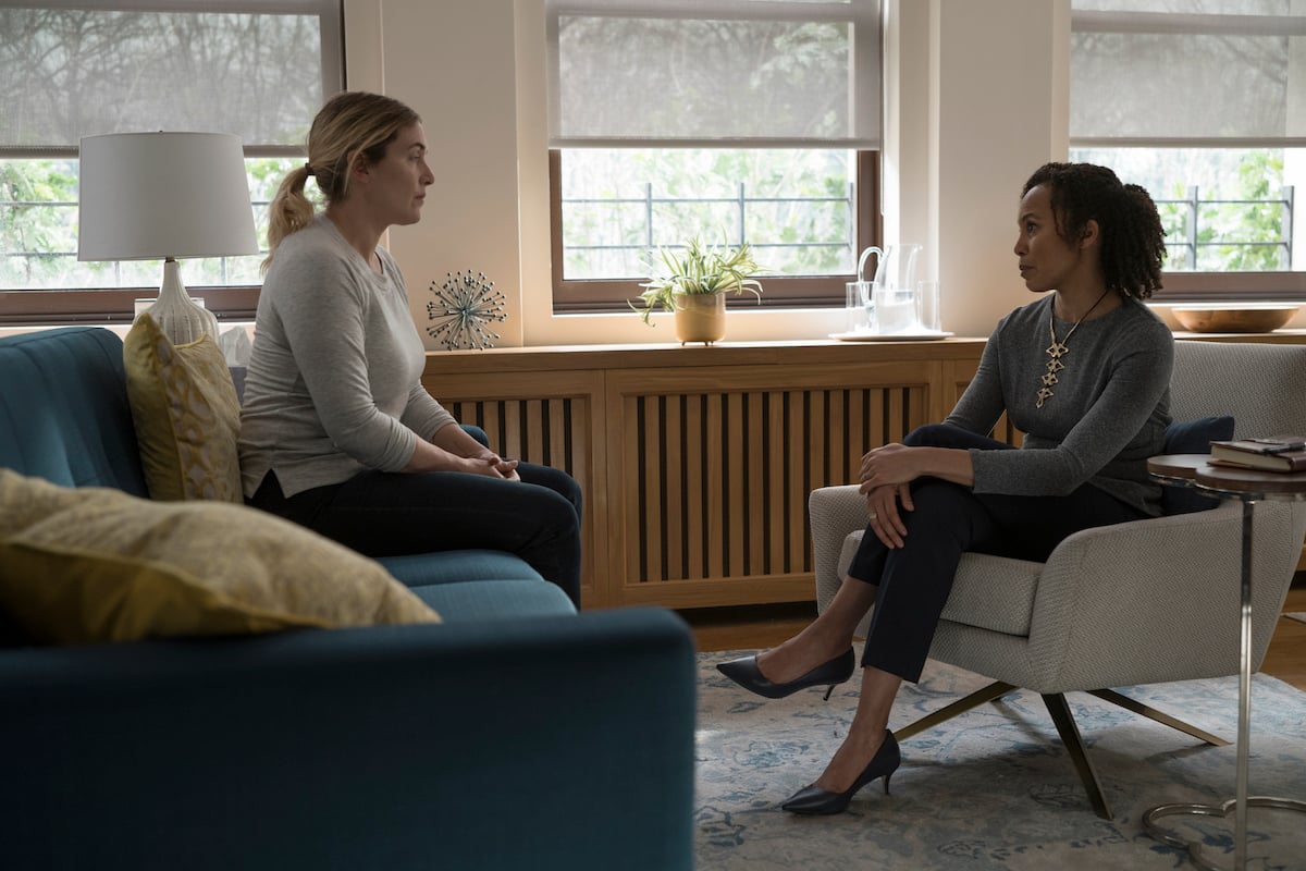 Kate Winslet sits on a couch across from Eisa Davis, who sits in a chair, on 'Mare of Easttown'