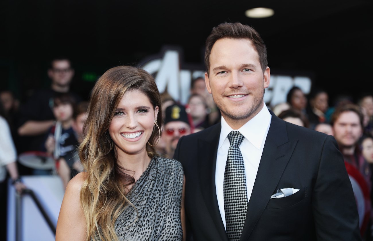 Katherine Schwarzenegger and Chris Pratt smiling together, fans in background