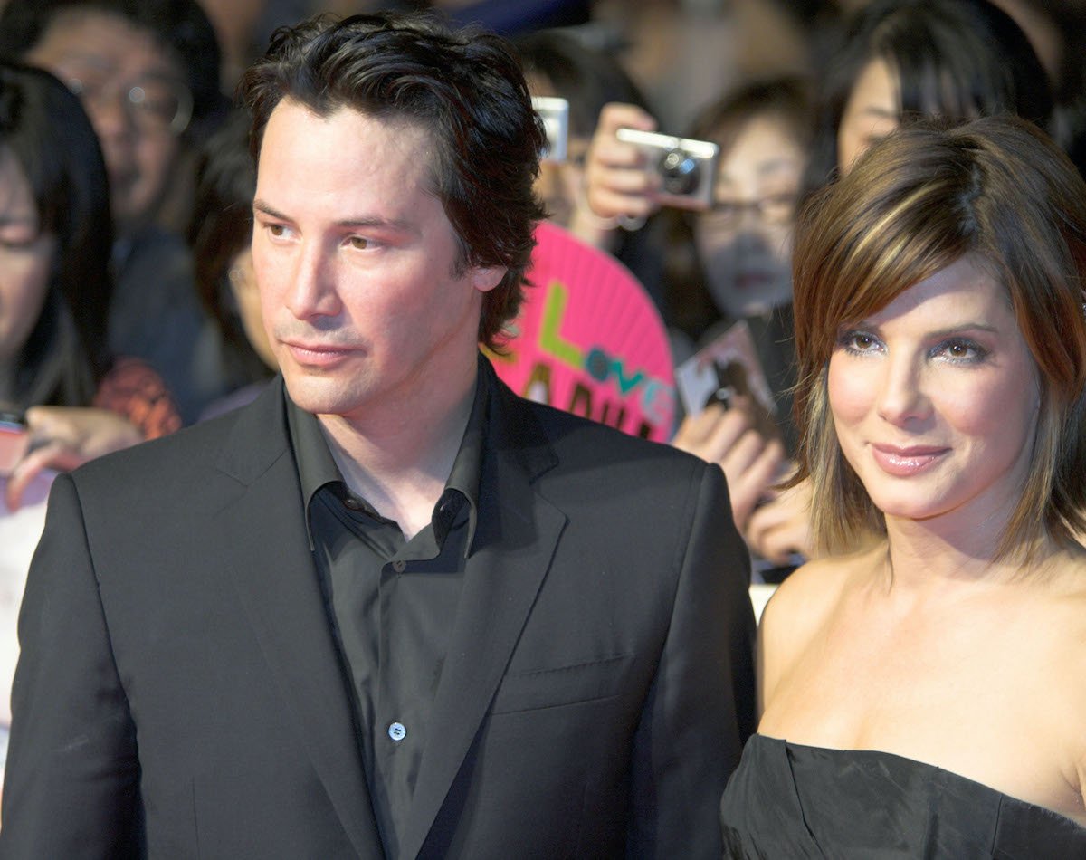 Keanu Reeves and Sandra Bullock walk the red carpet dressed in black during 'The Lake House' Tokyo premiere
