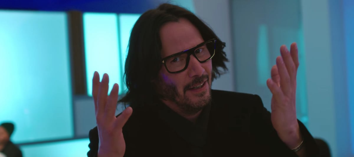 Keanu Reeves wears glasses and holds his arms up in 'Always Be My Maybe'