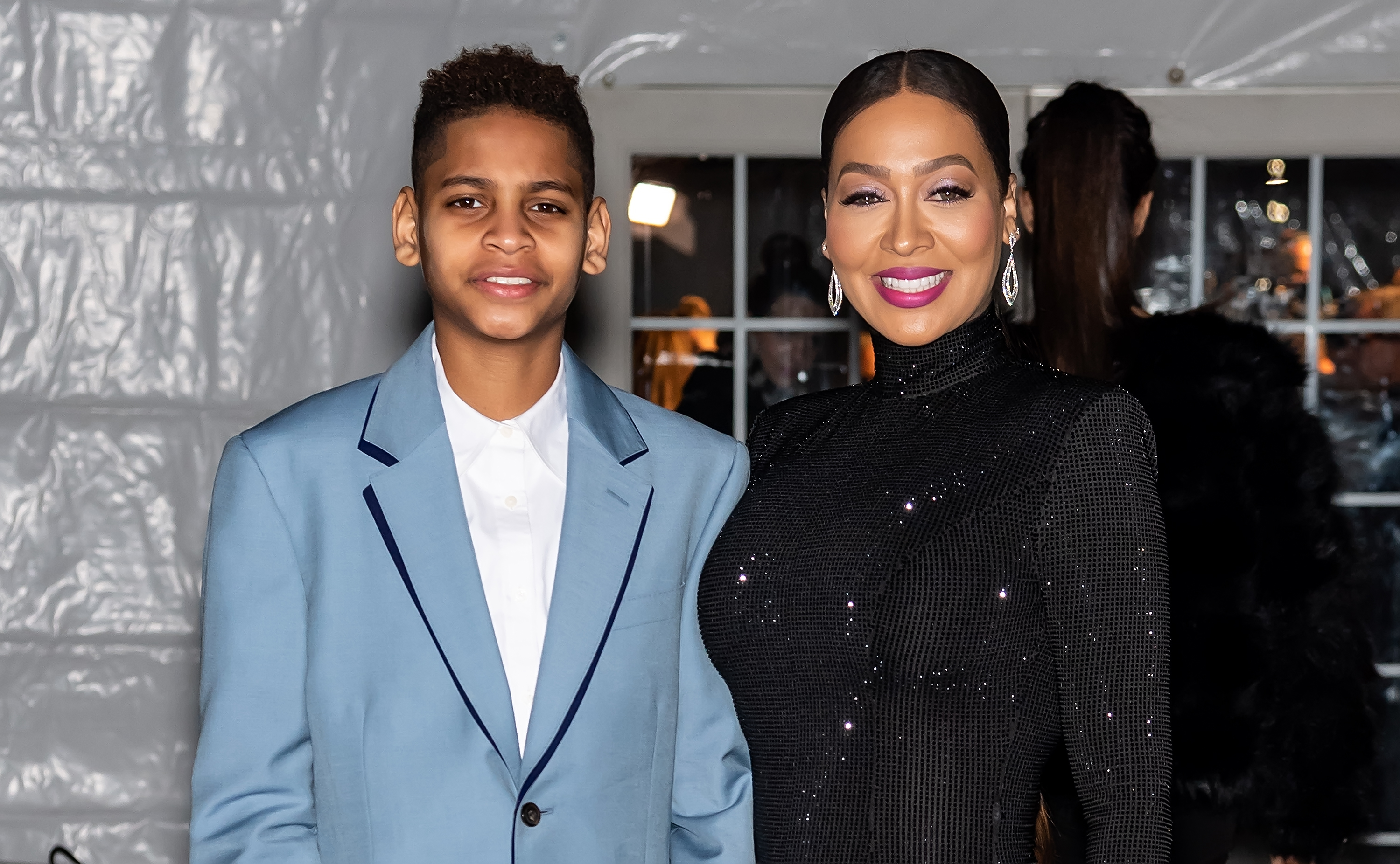 Kiyan Anthony standing and smiling next to his mother, La La Anthony.