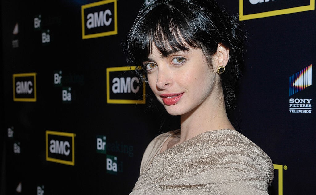 Krysten Ritter walks the red carpet in a gold dress at the 'Breaking Bad' Season 3 premiere.