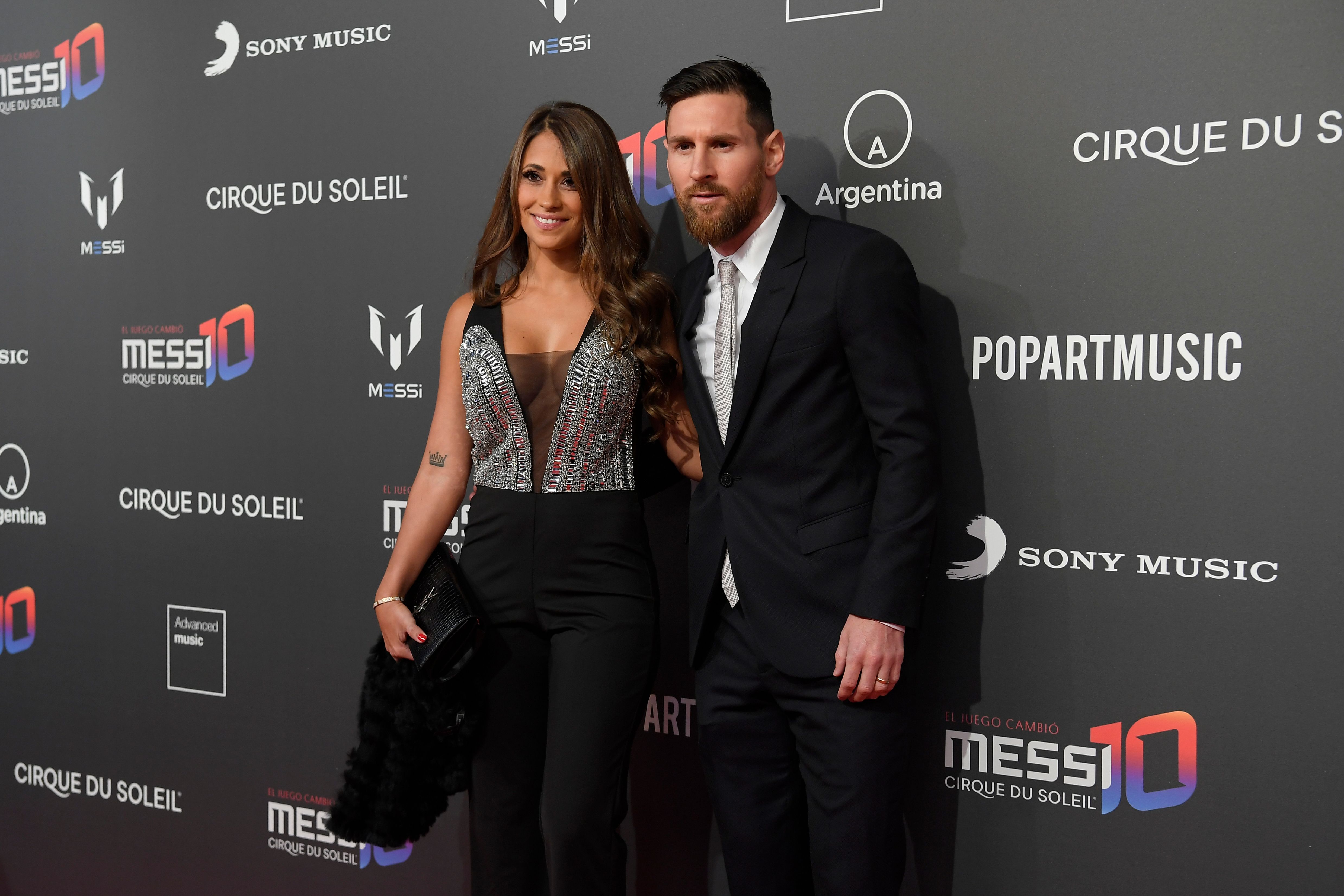 Lionel Messi and his wife Antonella Roccuzzo pose on the red carpet together during a photocall for Cirque du Soleil