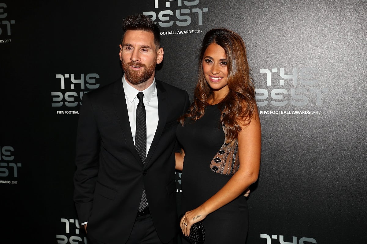 Antonella Roccuzzo (R) and Lionel Messi (L) arrive for The Best FIFA Football Awards