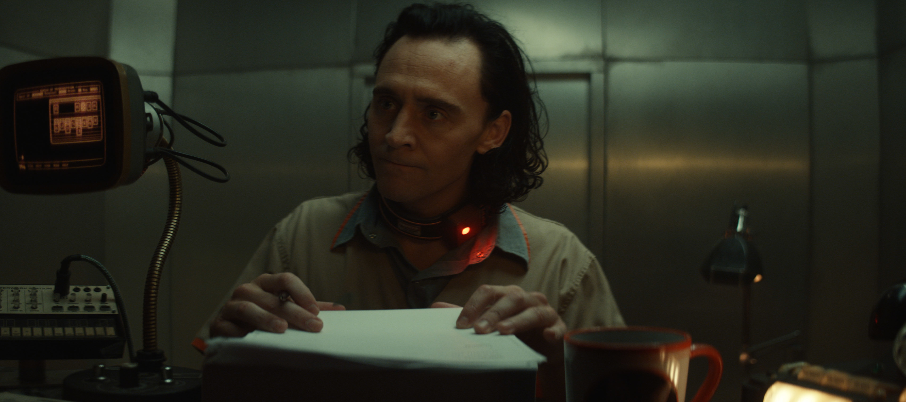 Loki: Tom Hiddleston sits at a desk