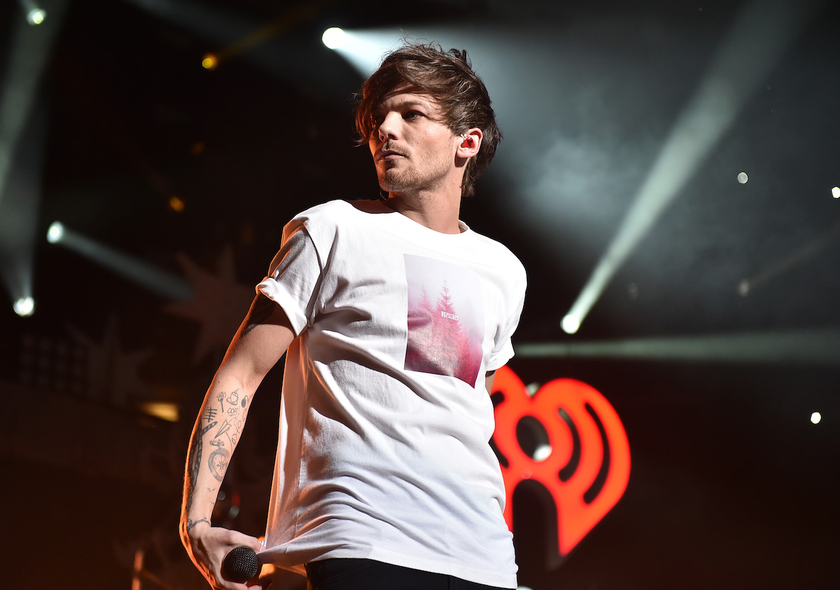 Louis Tomlinson in a white t-shirt on stage at Jingle Ball 2015