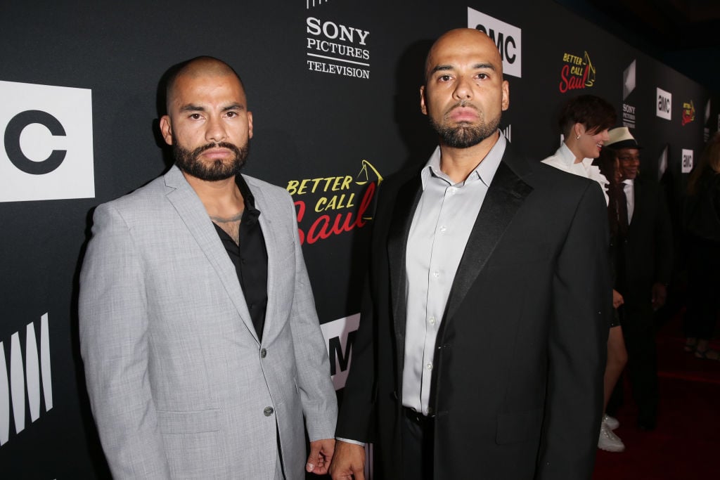 Luis and Daniel Moncada walk the red carpet together in suits.