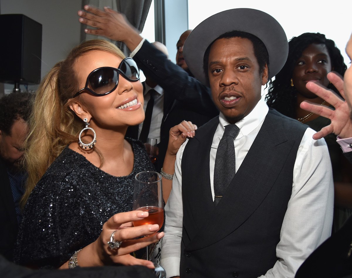 Mariah Carey and Jay-Z posing for a photo together at an event