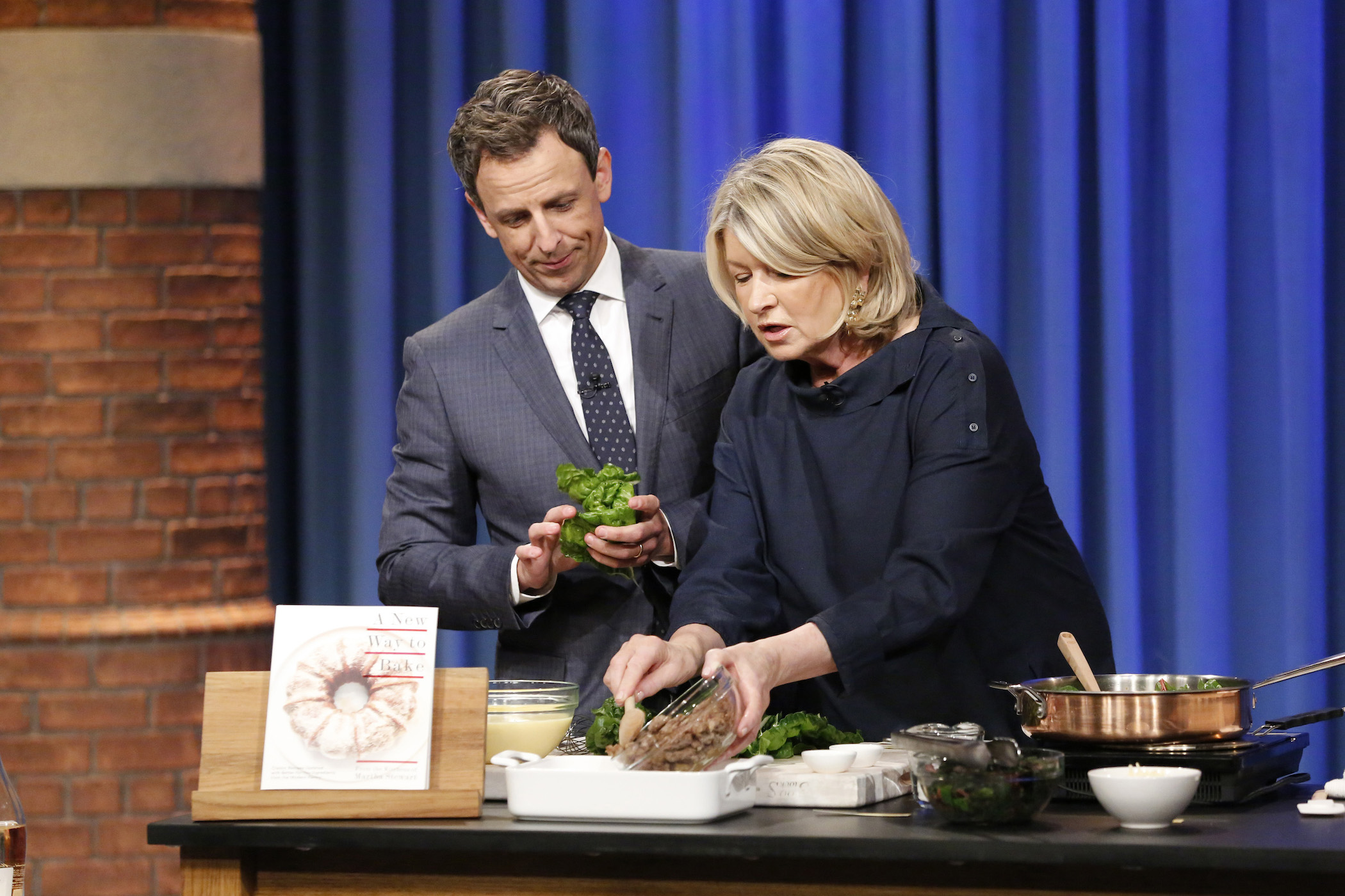 'Late Night' host Seth Meyers helping Martha Stewart cook her recipe on the show