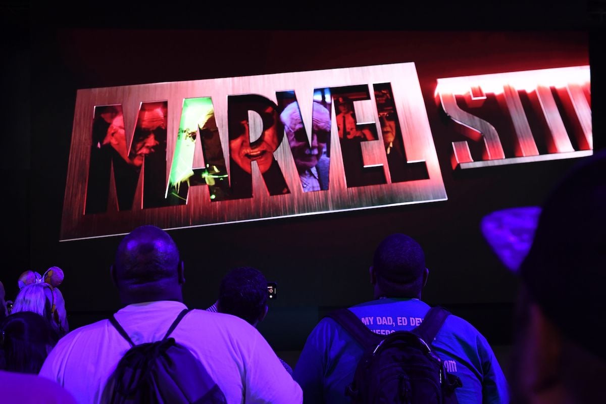 Attendees watch Marvel Studios visual at the Disney+ booth at the D23 Expo