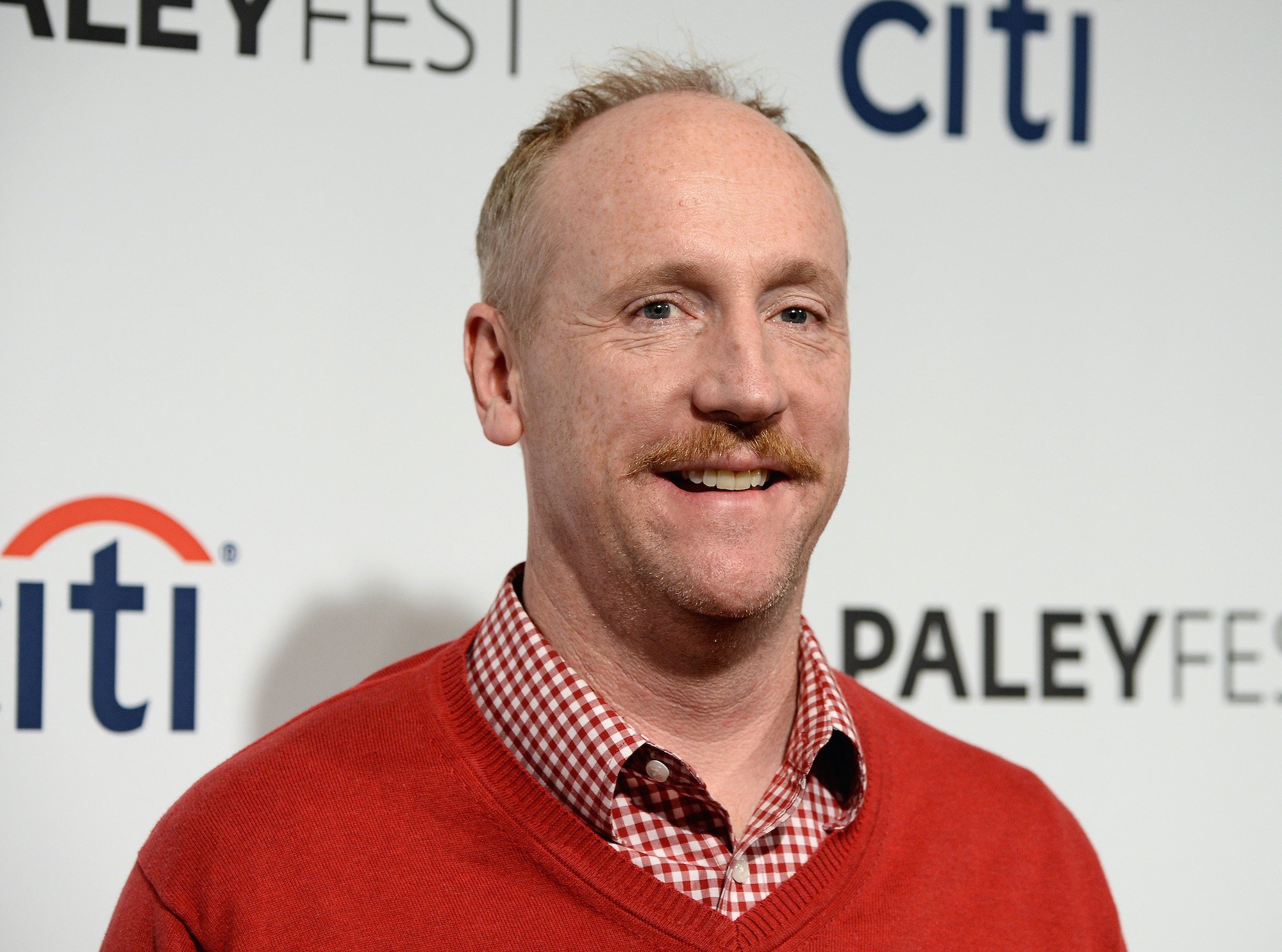 Matt Walsh smiling in front of a white background