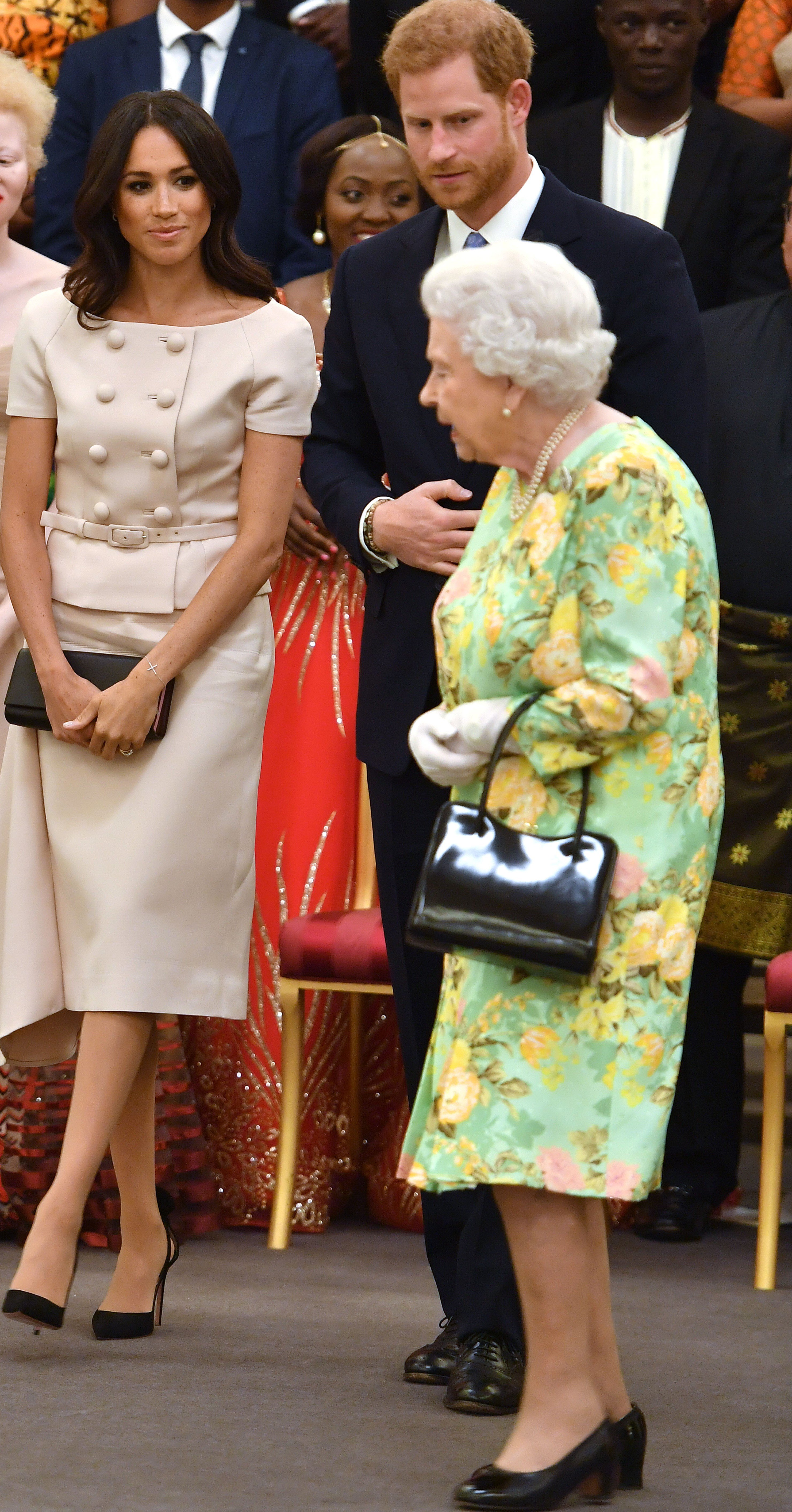 Meghan Markle with Queen Elizabeth II and Prince Harry at the Queen's Young Leaders Awards Ceremony at Buckingham Palace in 2018