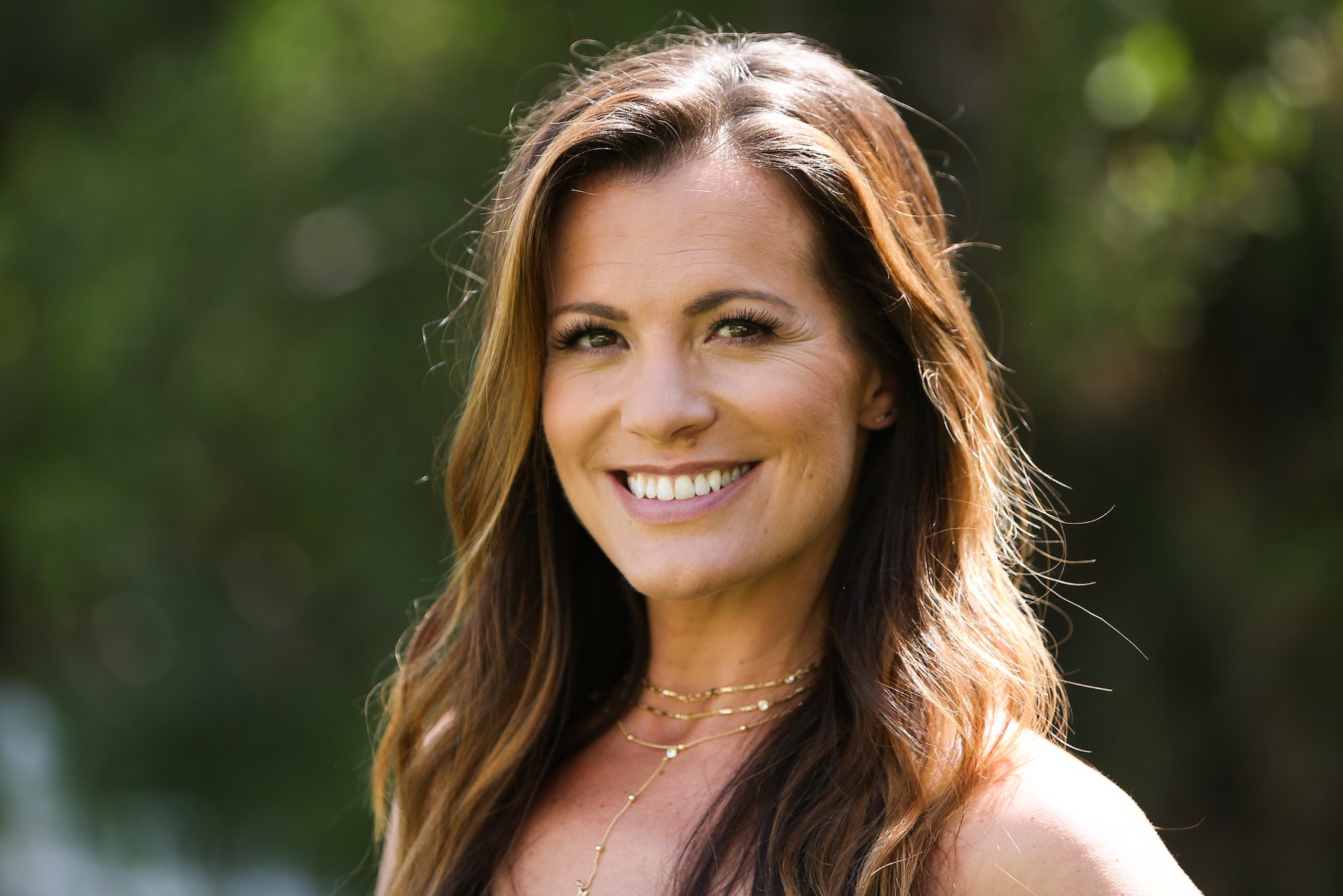 Melissa Claire Egan smiling in front of a green background