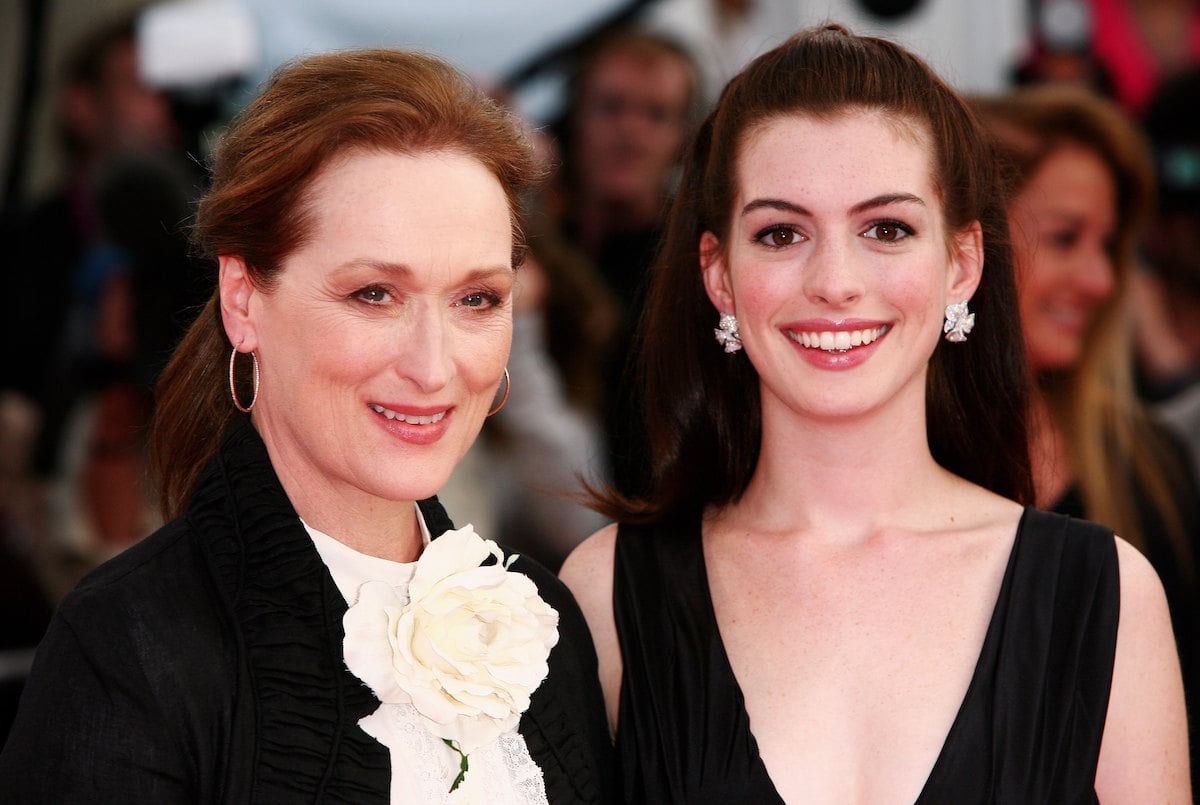 Meryl Streep wears a blouse and jacket and Anne Hathaway wears a black dress at the 'The Devil Wears Prada' premiere