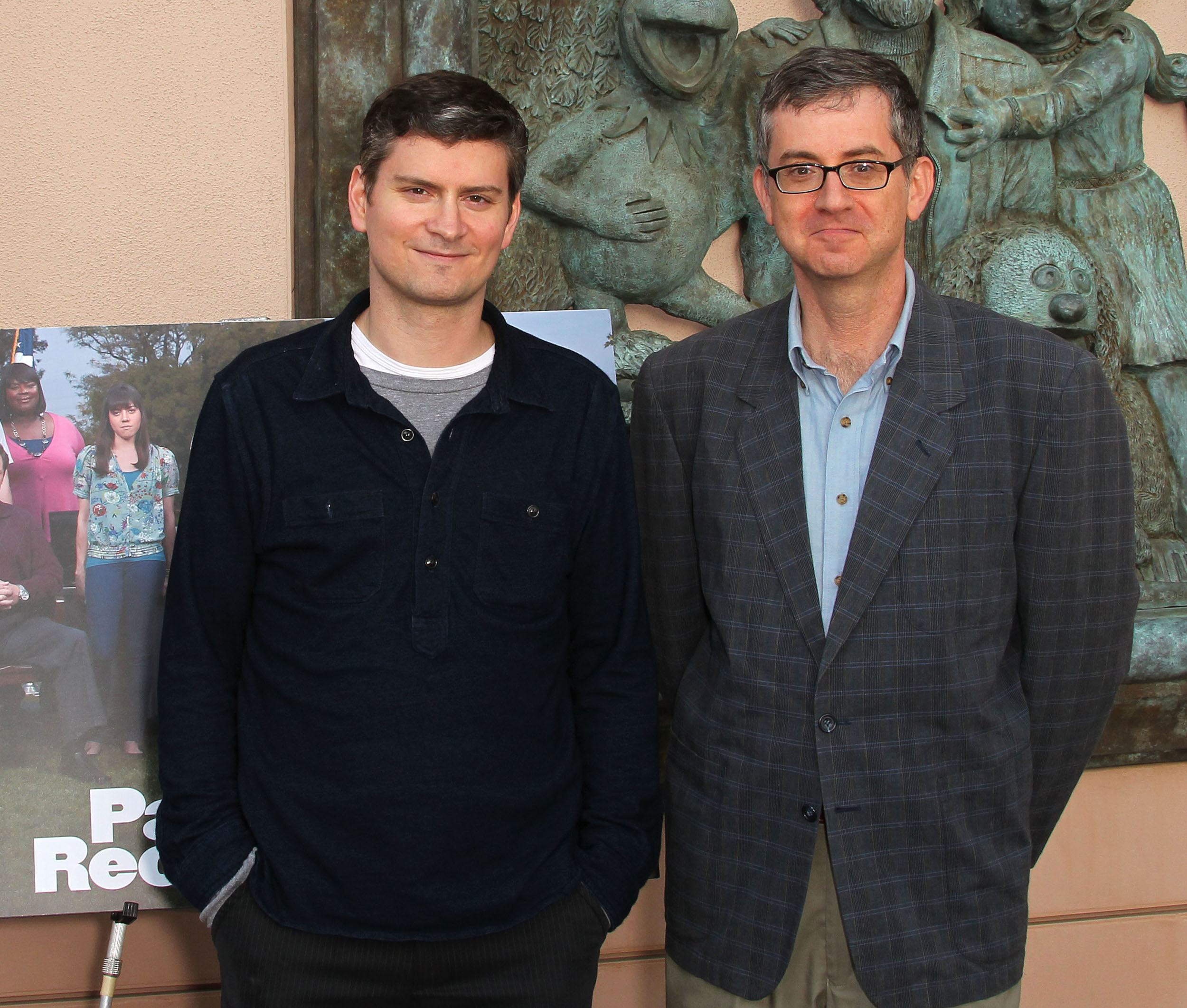 Mike Schur and Greg Daniels stand in front of a 'Parks and Recreation' sign at an Emmy screening
